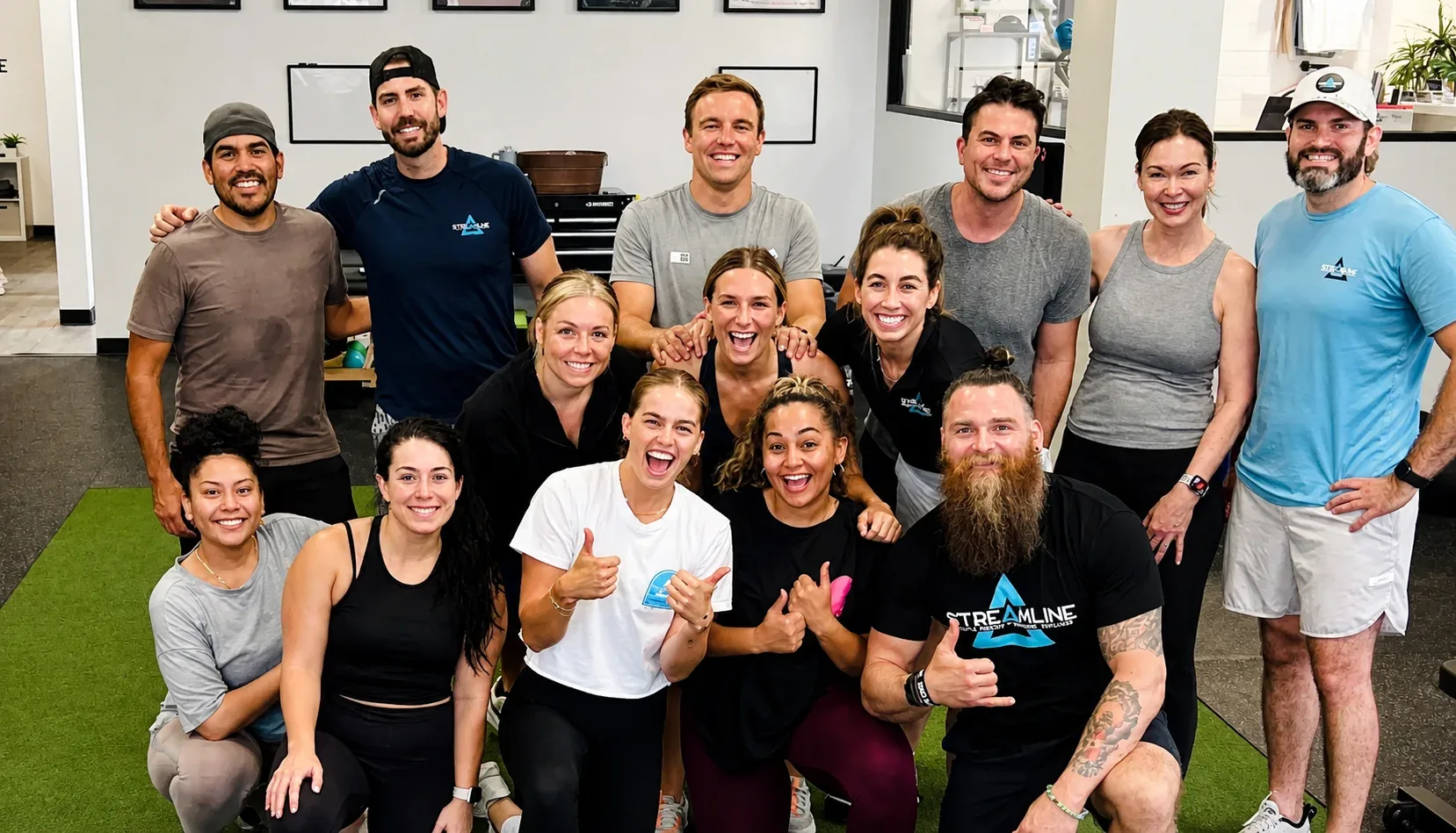 The Streamline Performance Physical Therapy team together on the turf at the Phoenix clinic